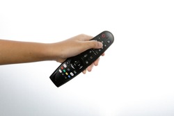 Malaysia, January 2021 : a man hand holding a television remote isolate on white background