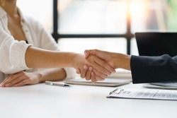 Business people shake hand to confirm the agreement in the business of mutual investment and agree on a unified work contract.
