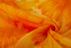 Background texture, orange silk fabric with painted meadow flowers