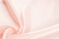 Texture, background, pattern. Fabric silk pink background. Beautiful pink satin. Drapery background. winds waves, creating a beautiful background of the folds.