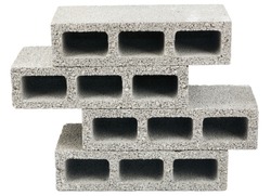 Three gray concrete construction blocks in a stack, isolated on white background.