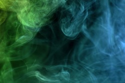 Cloud of  green and blue smoke on a black isolated background. Background from the smoke of vape