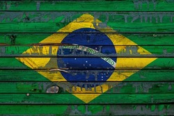 The national flag of Brazil is painted on uneven boards. Country symbol.
