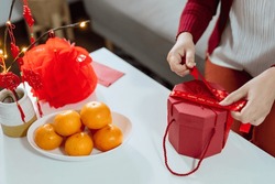 Asian Woman holding red gift box thankful present Lunar New Year. Chinese traditional holiday. Lunar new year culture