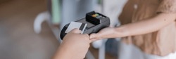 Contactless payment holding credit card with touch settlement paying for shopping nfc technology transaction cashless technology and credit card payment.