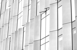 Black and white minimalist modern architectural image of glass windows and external shade covers