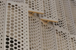 Gold perforated cladding on the outside of a building