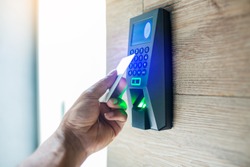 Door access control. Staff holding a key card to lock and unlock door at home or condominium. using electronic card key for access. electronic key and finger scan access control system to unlock doors