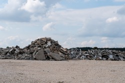 a construction site with gravel floor and a pile of broken rubble