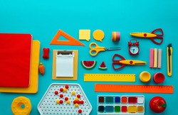 School supplies on blue background. Back to school. Kindergarten. Set for creativity with children. Child learns lessons.