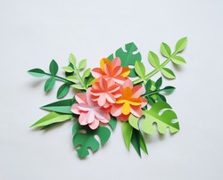 The colors of the paper. White background. Tropics. Paper flowers and leaves. Palma.