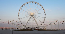 Ferris wheel in front of sky. Big carousel in Baku