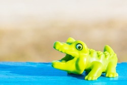Green crocodile. Animal hut. The toy crocodile opened his mouth