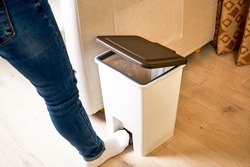Open the lid with your foot on the trash can pedal