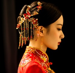 Beautiful Asian woman in wedding dress in dark background