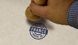 Made in France stamp and stamping hand. Factory, manufacturing and production country concept.