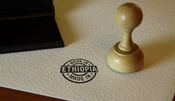 Made in Ethiopia stamp and stamping hand. Factory, manufacturing and production country concept.