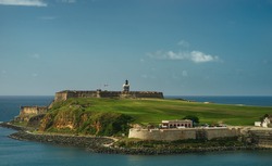 Scenic view of historic colorful Puerto Rico city in distance with fort in foreground san juan
