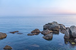 Twilght over the wild rocky beach coastline and the sea. Sea and rocks at night wide angle view. Panoramic landscape in Crimea, Nora, near Alupka town.