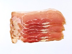 Slices of Speck, smoked pork belly on white background. It is originally from the Tyrol and german tradition and then spread with many variants throughout Europe.