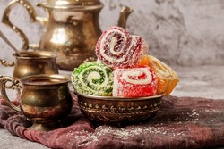 Traditional Turkish delight with Turkish tea on gray background. Ramadan Kareem celebration concept. Fragrant Turkish tea and Turkish sweets in national dishes.
