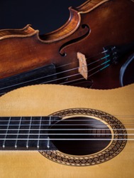 An old violin and a classical guitar