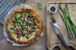 Spring food. Homemade savory pie with asparagus, ricotta and speck. Directly above.