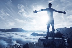 Man on a summit over an ocean of clouds