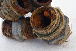Old metal pipes with rust and limestone