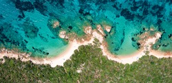 View from above, stunning aerial view of a rocky coastline with some beaches bathed by a beautiful and turquoise sea. Liscia Ruja, Costa Smeralda, Sardinia, Italy. 