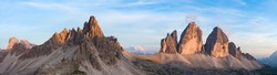 Stunning panoramic view of the Three Peaks of Lavaredo (Tre cime di Lavaredo) during a beautiful sunset. The Three Peaks of Lavaredo are the undisputed symbol of the Dolomites, Italy.	