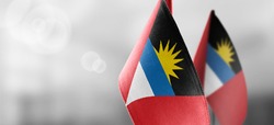 National flag of the Antigua and Barbuda on dark fabric