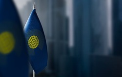 Small flags of Commonwealth on a blurry background of the city