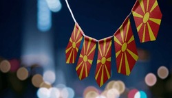 A garland of Macedonia national flags on an abstract blurred background.