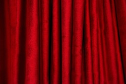 Theatrical red velvet curtain. Texture background for design. Horizontal photography.	