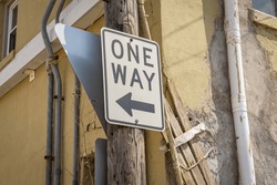 one way sign in an alley.