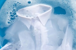 Shirt soak in powder detergent water dissolution, washing  cloth. Laundry concept