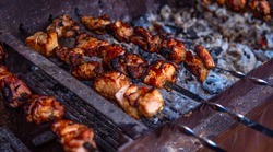 Fresh shish kebab on skewers is fried on the grill. Grilled meat on skewers. Cooking.