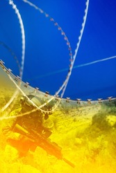 Conceptual poster of the war in Ukraine. Soldier and barbed wire on a yellow-blue background.