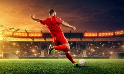 Soccer player kicks a ball. Action. Sports event. Night soccer stadium