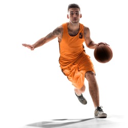 Basketball player in action with a ball isolated on white background. Dribbling