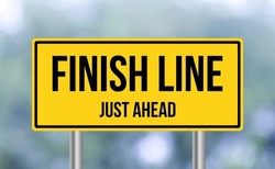 Finish Line just ahead road sign on blur background