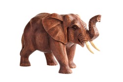 Carved wooden figure of an elephant with a trunk raised to the top. Isolated on white background