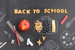 Back to school concept chalk board with accessories and lunch box note from cookies