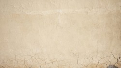 slightly pale yellow painted textured wall background with cracks                 