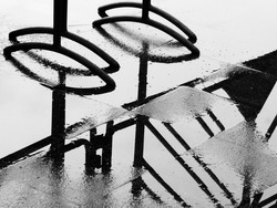 silhouette of traffic barrier on wet floor after rain, black and white style