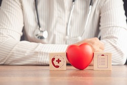 Annual health check concept. Checkup body. Closeup-of wooden cubes with healthcare medical icons and a red heart shape on the table. Healthcare medicine and Insurance concept
