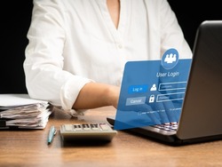 Login page username and password on a virtual screen. Businesswoman using a laptop login to the network system on a virtual screen. Business and technology concept