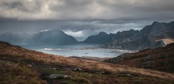 Heavy rain and sun over mountains and sea at Lofoten Islands in autumn Norway