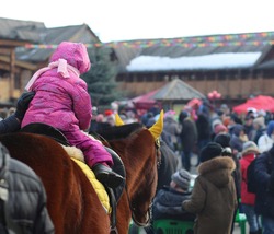 riding a little girl on a horse 